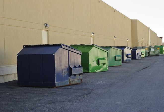 metal waste containers sit at a busy construction site in Chula